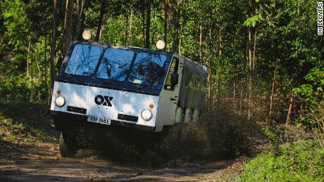 A pay-as-you-go electric truck makes deliveries on the dirt roads of Rwanda