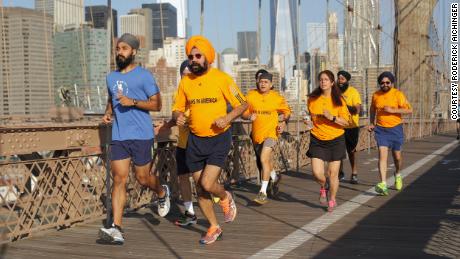 Singh (pictured in blue) runs across the Brooklyn Bridge with Sikhs at the city's running club.