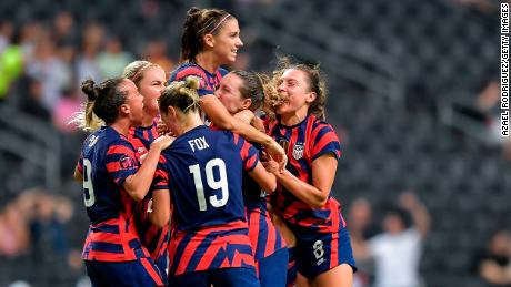 Alex Morgan celebrating with teammates after scoring the 2022 Concacaf W Championship-winning goal.