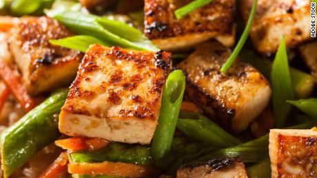 Homemade fried tofu with rice and green vegetables is a crowd pleaser.