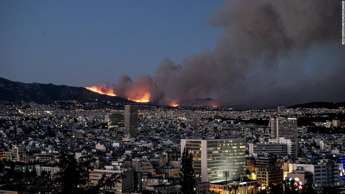 A wildfire burns atop a mountain in the northern suburbs of Athens on July 19.