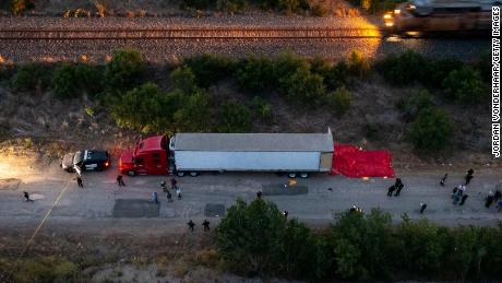 Members of law enforcement investigate the tractor-trailer on June 27, 2022 in San Antonio, Texas.