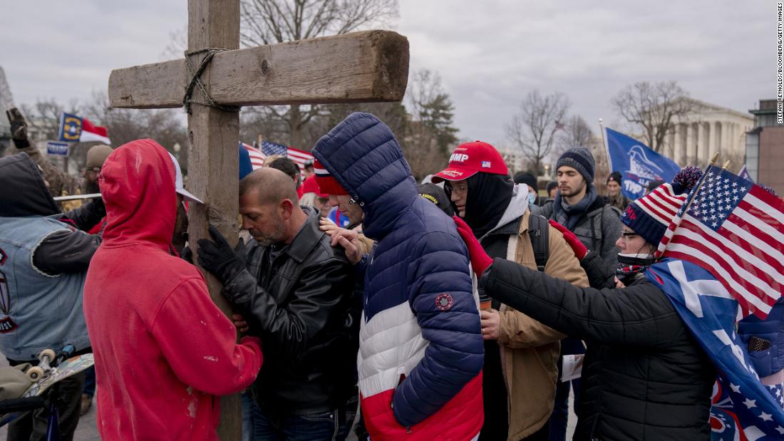 Demonstrators pray outside the US Capitol in Washington on  January 6, 2021.