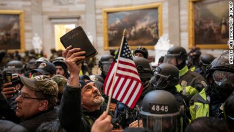 A protester holds up a Bible amid the crowd storming the US Capitol Rotunda in Washington  on January 6, 2021. 