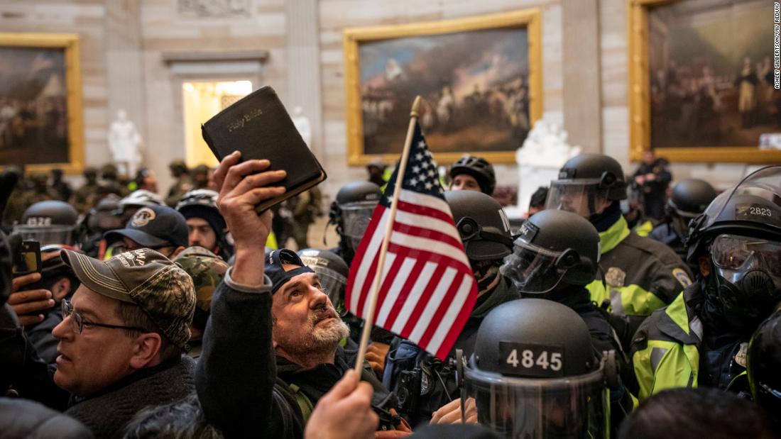 A protester holds up a Bible amid the crowd storming the US Capitol Rotunda in Washington  on January 6, 2021. 