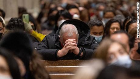 A parishioner bows his head to pray while celebrating midnight Mass at St. Patrick&#39;s Cathedral on December 24, 2021, in New York City. 