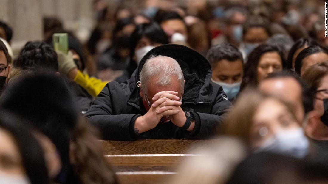 A parishioner bows his head to pray while celebrating midnight Mass at St. Patrick's Cathedral on December 24, 2021, in New York City. 