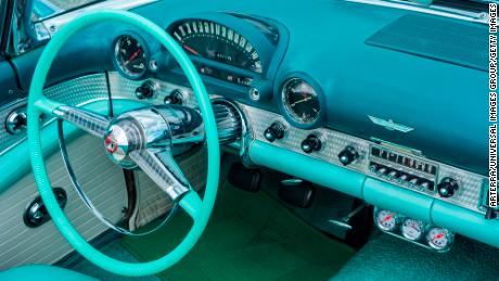 Vintage 1955 Ford Thunderbird interior showing steering wheel and dashboard in teal and aqua colors. (Photo by: Arterra/Universal Images Group via Getty Images)