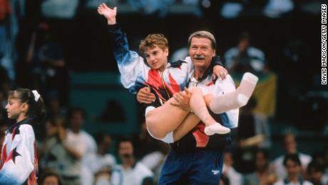 Keri Strug is flown from the United States by coach Bella Karolyi during the team competition in the women's gymnastics event at the 1996 Summer Olympics held July 23, 1996 at the Georgia Dome in Atlanta.