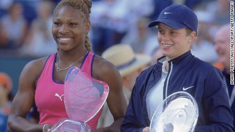 Kim Clijsters, right, and Serena Williams pose with their cups after the game at the Indian Wells Tennis Gardens in Indian Wells, California.
