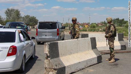 Uzbek service members guard a road in Nukus on July 6, 2022.