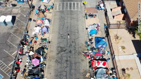     Aerial view of people gathering near a homeless camp in Phoenix, Arizona, Thursday afternoon. 