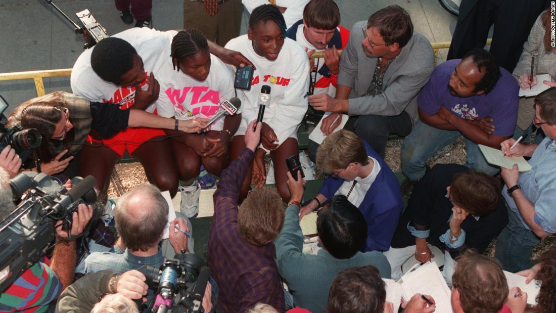 Serena sits with her father and sister Venus as Venus answers questions from the press in 1994. Venus turned professional at the age of 14. Her sister followed one year later when she was the same age.
