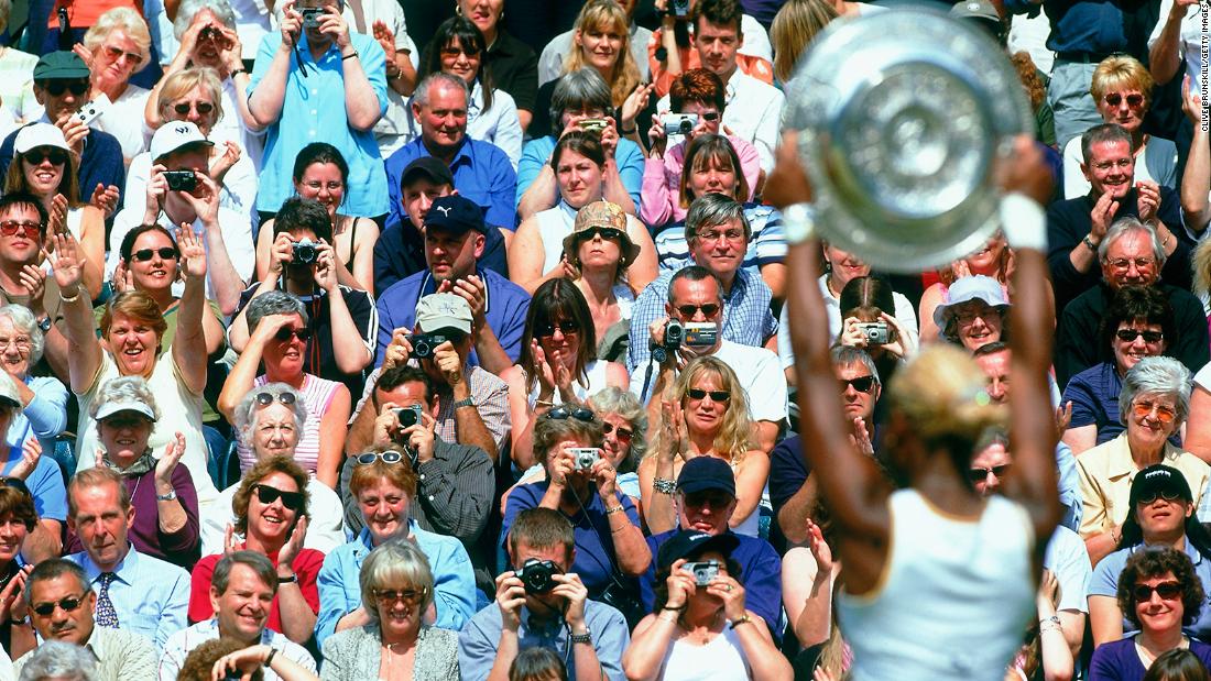 Serena poses with the trophy after winning her first Wimbledon title in 2002. She was No. 1 in the world at the age of 20.