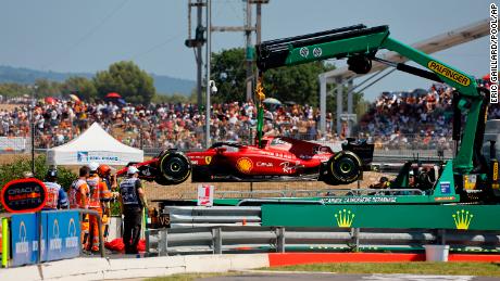 Track marshals remove Leclerc's after he crashed into the track wall.