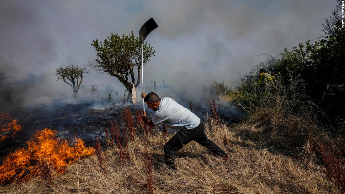 A local resident fights a fire with a shovel in Tabara, Spain, on July 19.