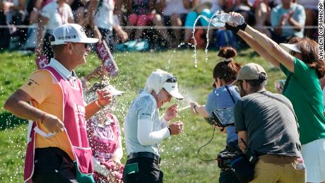 Brooke Henderson in the center celebrates after winning the Evian Championship.