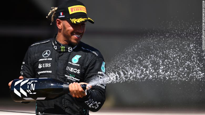 Lewis Hamilton celebrates on the podium after coming second in the French Grand Prix.