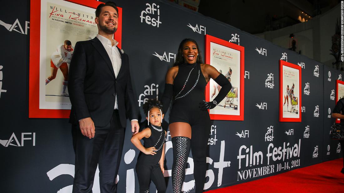 Williams poses with her daughter and husband at a premiere of the film &quot;King Richard&quot; in 2021. The film is based on Williams&#39; father and how he raised his girls to become tennis champions.