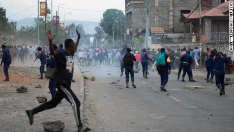 Congolese policemen disperse protesters along the road near the compound of a United Nations peacekeeping force&#39;s warehouse in Goma in the North Kivu province of the Democratic Republic of Congo July 26, 2022.