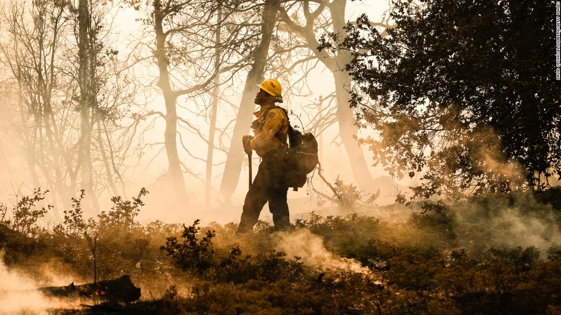 A firefighter monitors a backfire operation in Mariposa County on Sunday.