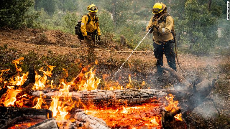 Firefighters mop up hot spots while battling the Oak Fire in the Jerseydale community of Mariposa County, California, on Monday, July 25.