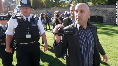 Blogger Graham Phillips is escorted away by police officers after he disrupted a press conference by Bellingcat founder Eliot Higgins, report author Christo Grozev and MP Bob Seely opposite the Houses of Parliament in London, Britain, October 9, 2018. 