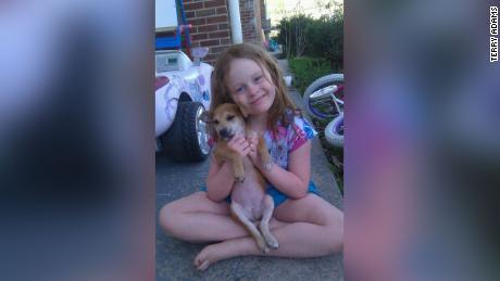 Picture of a much younger Chloe with her dog, Sandy, who she rescued. &quot;This is them many moons ago,&quot; Terry Adams, Chloe&#39;s father, told CNN. 