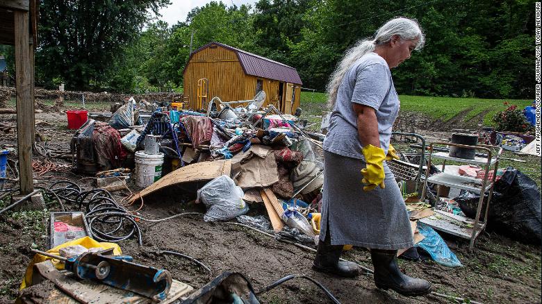 Libby Duty, 64, of Jenkins, Kentucky walked through her back yard while clearing out her basement on Saturday after historic rains flooded many areas of eastern Kentucky.