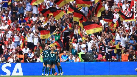 Germany players celebrate Magull&#39;s equalizer.