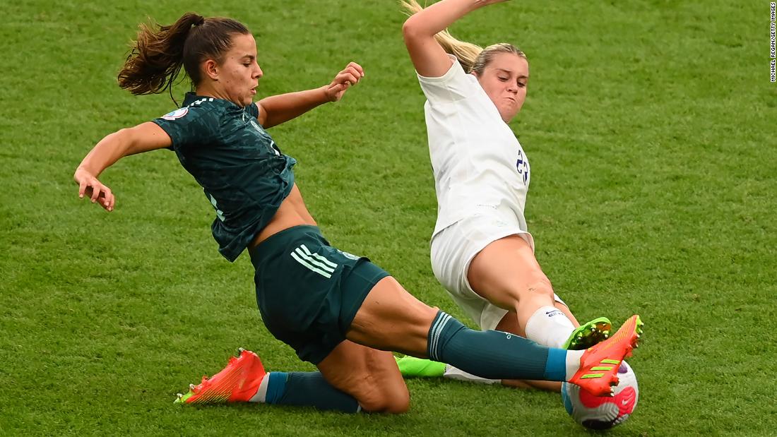 Lena Oberdorf of Germany is challenged for the ball by Alessia Russo of England.