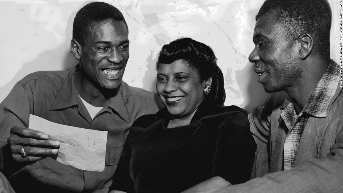 From left, Russell shows his parents Katie and Charles Russell a telegram informing him he made the first string All-American team in Oakland, California, in February 1955.