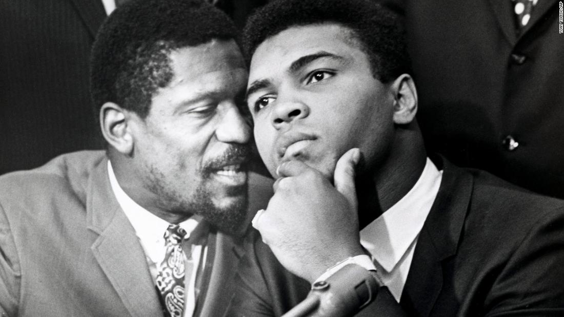 Russell, left, speaks with boxer and fellow civil rights trailblazer Muhammad Ali, in Cleveland, Ohio, in 1967. The two were joined by other Black athletes at a news conference in support of Ali&#39;s refusal to fight in the Vietnam War.