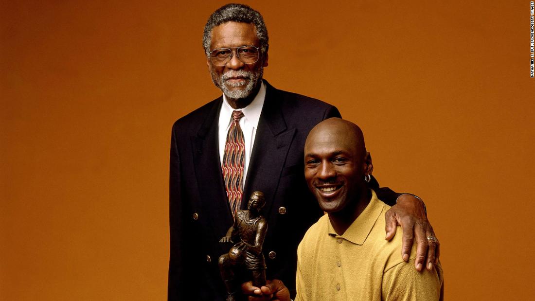 Russell poses for a portrait with Michael Jordan and his NBA Most Valuable Player trophy in Chicago in 1998.