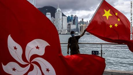 A man waves the Chinese flag to celebrate the 25th anniversary of Hong Kong&#39;s handover from Britain to China on July 1, 2022. 