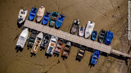 Boats sit on the dry bed of Brenets Lake on the border of France and Switzerland on July 18.