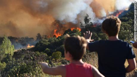 People looking at a forest fire near Gignac in southern France on July 26. 