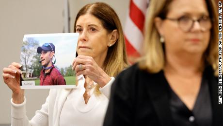 Linda Beigel Schulman holds a photo of her son, Scott Beigel, before giving her victim impact statement Monday during the penalty phase of Marjory Stoneman Douglas High School shooter Nikolas Cruz&#39;s trial at the Broward County Courthouse in Fort Lauderdale, Florida. 