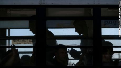 Ukrainians seeking asylum in the United States are seen on a bus in Tijuana, Mexico, in April.  Since Russia & # 39; s invasion of Ukraine began, some 100,000 Ukrainians have come to the United States through various immigration channels.  Officials say a recently reported phishing scam targeted prospective US-based sponsors trying to help Ukrainians.