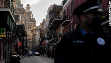 An NOPD officer stands before an empty Bourbon Street on February 16, 2021 in New Orleans, Louisiana. 