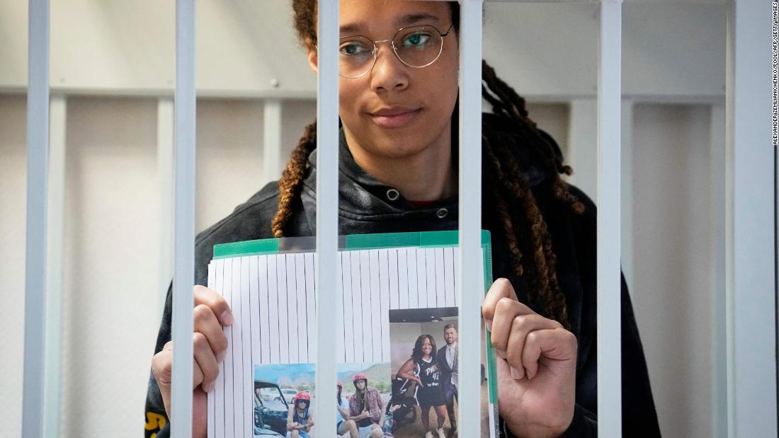 Griner holds photographs standing inside a defendants&#39; cage before a hearing on July 26, 2022.