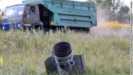 KHARKIV REGION, UKRAINE - JULY 30, 2022 - A Russian missile is stuck in the ground as the harvest season is underway in the northern part of the region despite Russian shelling, Kharkiv Region, northeastern Ukraine. This photo cannot be distributed in the Russian Federation. (Photo credit should read Vyacheslav Madiyevskyy/ Ukrinform/Future Publishing via Getty Images)