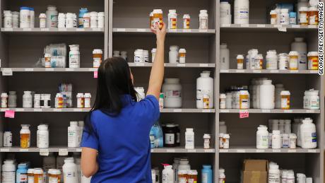 A pharmacy technician grabs a bottle of drugs off a shelve at the central pharmacy of Intermountain Heathcare on September 10, 2018 in Midvale, Utah. 