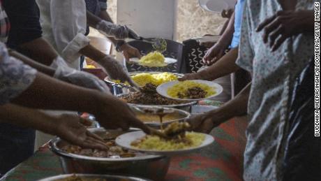 Volunteers serve free meals to people in need at a community kitchen in Colombo, Sri Lanka on Aug.  4.