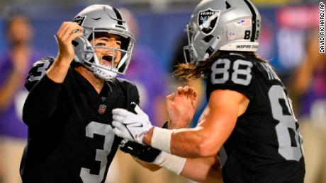 Las Vegas Raiders quarterback Jarrett Stidham celebrates with tight end Jacob Hollister after scrambling for a touchdown during the first half against the Jacksonville Jaguars.