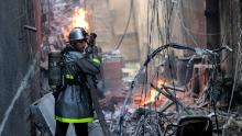 A Palestinian firefighter fights the blaze amid the destruction following an Israeli air strike on Gaza City, on August 5, 2022.