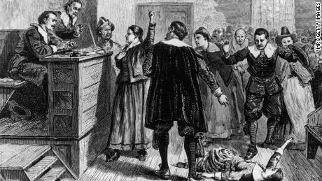 In this illustration, a young woman accused of witchcraft in Salem, Massachusetts, attempts to defend herself before Puritan ministers.
