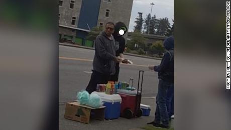 A man stiffed an 11-year-old boy with a fake $100 bill to buy lemonade from his stand. Everett Police has obscured a second individual in the photo. 