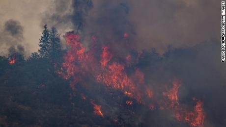 Flames make run uphill in the McKinney Fire on August 1.