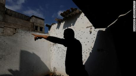 A Palestinian man inspects a damaged house in the northern Gaza Strip on Saturday.